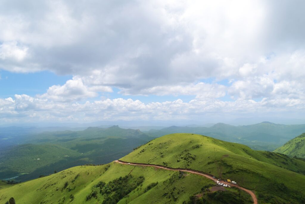 Scenic Coorg hill station featuring lush coffee plantations, mist-covered hills, and vibrant green valleys in Karnataka