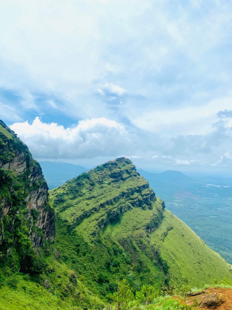 Wayanad Hills – Scenic Hill Station Near Bangalore Panoramic view of Wayanad Hills with lush greenery, misty mountains, and dense forests in Kerala